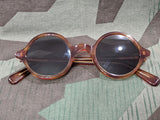 Reproduxtion WWII German round rimmed sunglasses with a faux tortoise shell pattern and tinted lenses. Vintage 1940s style.